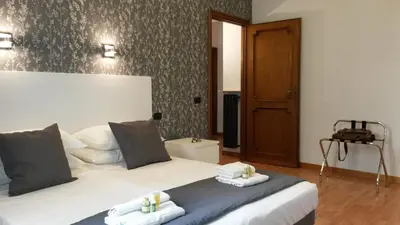 a bedroom with a bed with two towels at LCH-Lateran Charming House in Rome