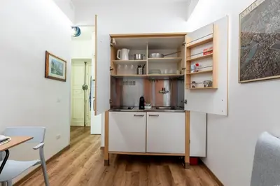 a kitchen with white cabinets and a table at Casa Crispi by Hili in Rome