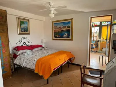 a bedroom with a bed with an orange blanket on it at Terrazza di Antonio in Rome