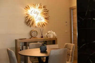 a dining room with a table and a clock at City Vibe Red Rose in Rome