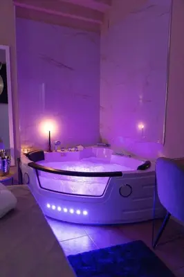 a purple room with a tub with a purple lighting at City Vibe Red Rose in Rome