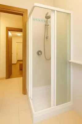 a shower in a bathroom with a glass door at Colosseum window 1800-Romantic apartment Rome in Rome