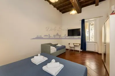 a living room with a bed and a couch at DEB Suite Campo de' fiori nel cuore di Roma in Rome