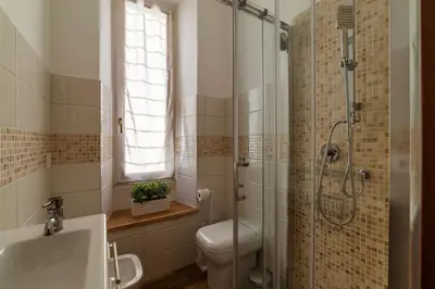 a bathroom with a shower and a toilet and a sink at CS Beautiful San Giovanni Apt in Rome