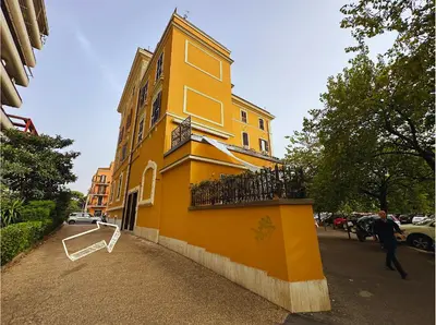 a yellow building on the side of a street at Casa Happya - Metro A - Central Rome in Rome