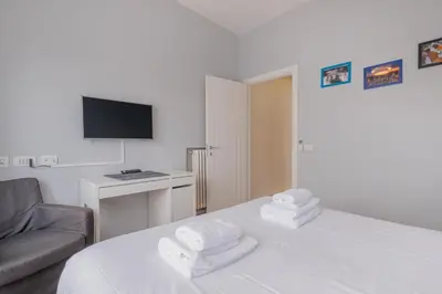 a bedroom with a bed and a couch and a television at BBB House Saint Peter in Rome