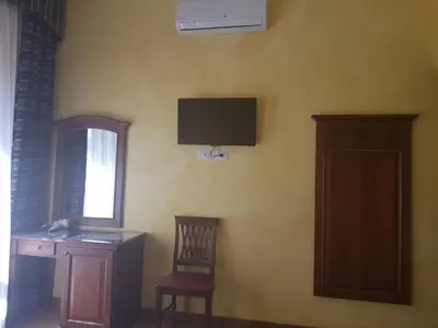 a room with a desk and a television on the wall at Pitagora House in Rome