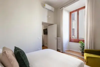 a bedroom with a white bed and a window at Casa Gracchi by Hili in Rome