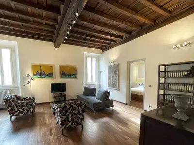 a living room with a couch and chairs and a tv at DeLUX Apartment in Rome