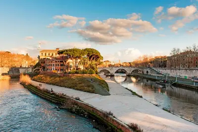 a bridge over a river with buildings and a city at DeLUX Apartment in Rome