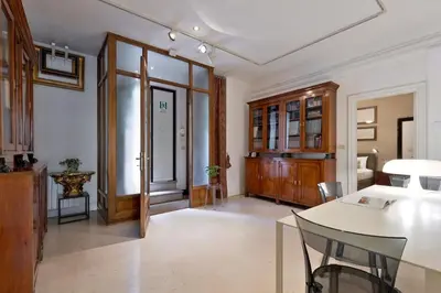a living room with a table and a dining room at Luxurious home of the antiquarian at Spanish Steps in Rome