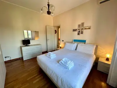 a bedroom with a white bed with two towels on it at Capa's Boccea in Rome