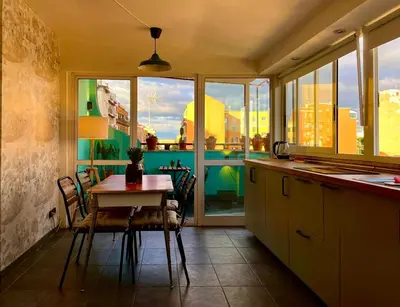 a kitchen with a table and chairs and a window at Stanza in appartamento adiacente metro C in Rome