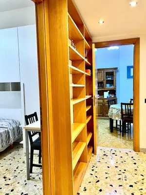 a bedroom with a room with a bed and a book shelf at New House in Rome