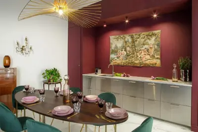 a dining room with a table and a painting on the wall at Daplace - Lucilla Apartment in Rome