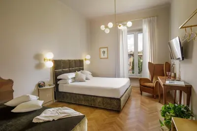 a bedroom with a bed and a living room at Daplace - Lucilla Apartment in Rome