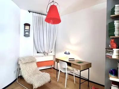 a desk and chair in a room with a window at The Garden in Parioli in Rome