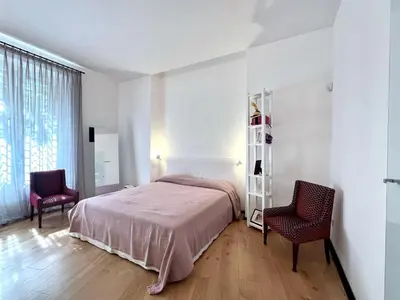 a bedroom with a bed and two chairs at The Garden in Parioli in Rome