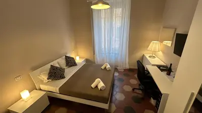 a bedroom with a bed and a desk with a computer at Vaticano Roma Guesthouse in Rome