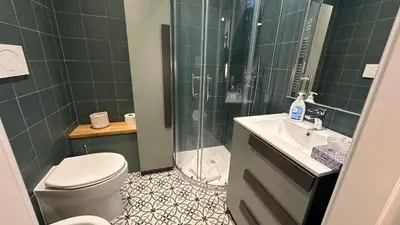 a bathroom with a shower and a toilet and a sink at Vaticano Roma Guesthouse in Rome