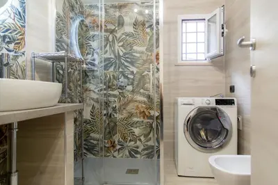 a bathroom with a washing machine and a sink at La casa di Nonna Peppina a Trastevere in Rome