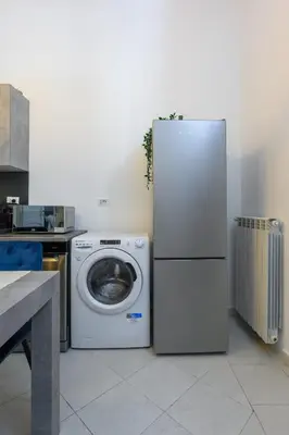 a refrigerator and a washing machine in a kitchen at HB Montebello apartment in Rome