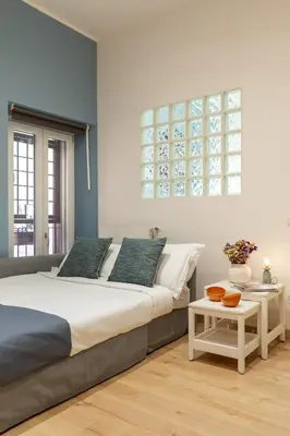 a bedroom with a large bed and a table at Trevi Fountain Boutique Apartment in Rome