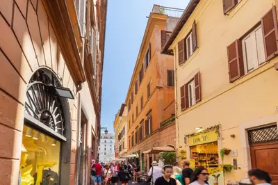 a group of people walking down a street with buildings at Trevi Fountain Boutique Apartment in Rome