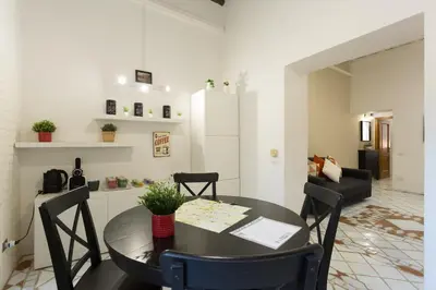 a hallway with a table and a large painting on the wall at San Peter Borgo 68 in Rome