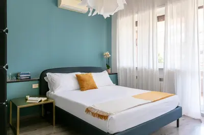 a bedroom with a bed with a blue wall at Fleming 67 by Hili in Rome
