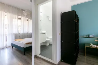 a bathroom with a mirror and a bed and a sink at Fleming 67 by Hili in Rome