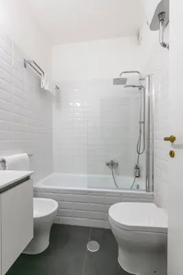 a white bathroom with a tub and a toilet and a sink at Fleming 67 by Hili in Rome