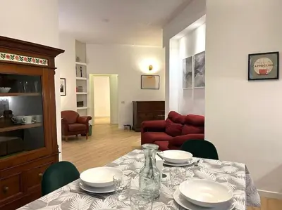 a living room with a table with plates on it at Appartamento con giardino tra San Pietro e Stadio Olimpico Roma in Rome