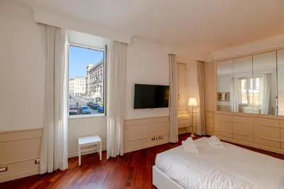 a bedroom with a bed and a large window at City Center Apartment - Pantheon in Rome