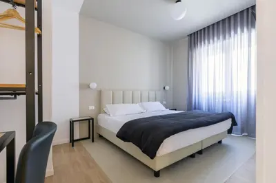 a bedroom with a large bed and a window at Luciano Queen's Guest House in Rome