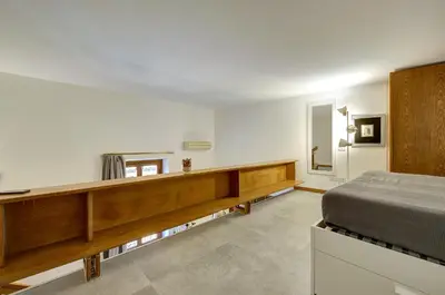 a bedroom with a bed and a desk in it at Dimora dell'Orso in Rome