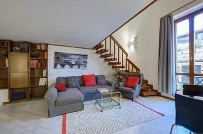 a living room with a couch and a staircase at Dimora dell'Orso in Rome