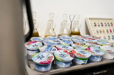 a shelf with a bunch of containers of yogurt at Casa per Ferie Santa Maria alle Fornaci in Rome
