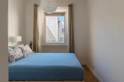a bedroom with a blue bed and a window at Valenziani Escape - Pretty Homes in Rome