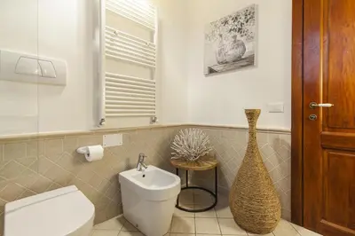 a bathroom with a white toilet and a sink at Campo dei Fiori Nest Apartment in Rome