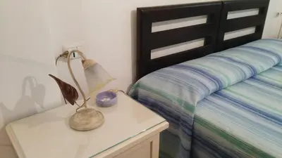 a bedroom with a bed with a lamp on a night stand at Piccolo Nido in Rome