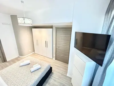 a living room with a large flat screen tv at Un Letto Ideale EUR - UN LETTO IDEALE in Rome