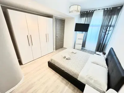 a bedroom with a bed and a large window at Un Letto Ideale EUR - UN LETTO IDEALE in Rome