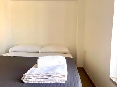 a bedroom with a bed with towels on it at Trastevere Grand Suites in Rome