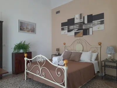 a bedroom with a bed with white walls at Casa Roma Affittacamere in Rome