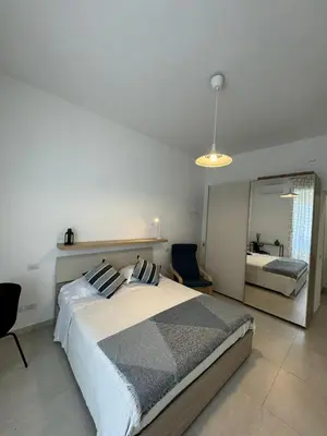 a bedroom with a large bed and a mirror at Alba Nuova Suite in Rome