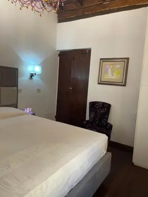 a bedroom with a large bed and a chair at Giglio apartment Navona in Rome