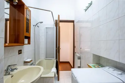 a small bathroom with a sink and a tub at A casa da Giordi in Rome