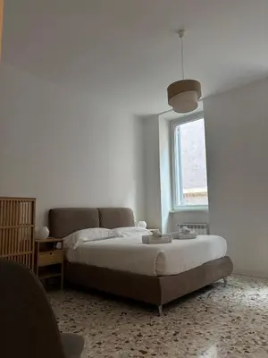a bedroom with a bed and a couch and a window at Harmony in Rome ll in Rome