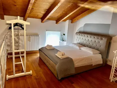 a bedroom with a bed and a ladder in it at Casa di Nia Pietralata in Rome